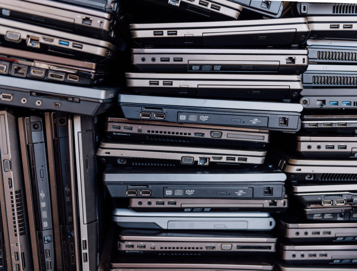 stack of old and used laptops